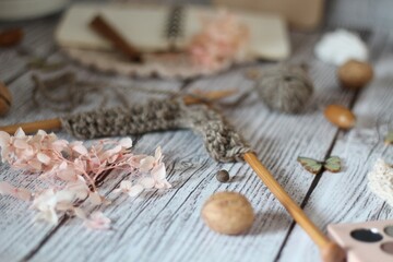 Knitting process, needles, cup of tea and different objects on the table beautiful photo	
