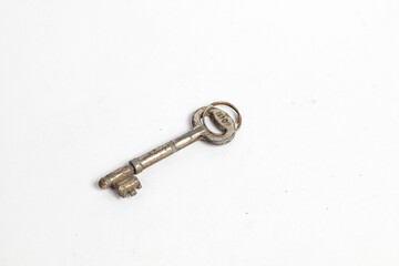 rusty house key isolated white background.