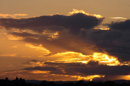 Bright white clouds drifting across deep blue sky