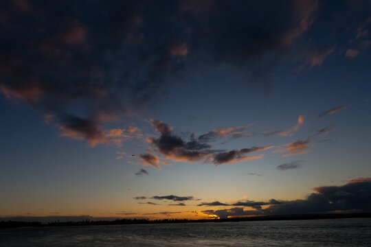 Bright white clouds drifting across deep blue sky
