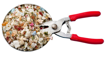 Close up of colorful mineral crystals and herbs in round container with red handled pliers