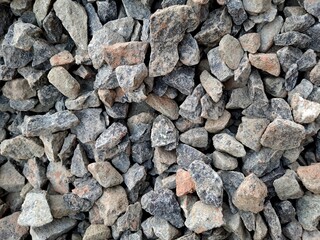 close up of crushed rock, stone raw material for construction industry. background and texture.  