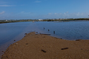 Salt marshes reflecting the blue sky near the city of faro in portugal