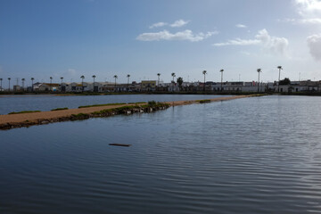 Salt marshes reflecting the blue sky near the city of faro in portugal