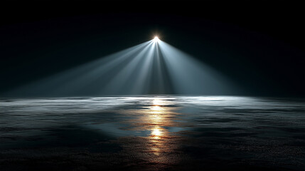 Obraz premium A powerful, single spotlight shines down from above, creating a bright cone of light that dramatically illuminates a wet, reflective floor in an otherwise dark, empty room.