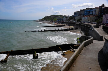 Cromer coastal path and skyline at high tide under the midday sum