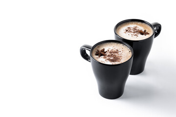 Chai Latte in Black Mug with Spices( star anise and cinnamon) isolated on white background. Copy...