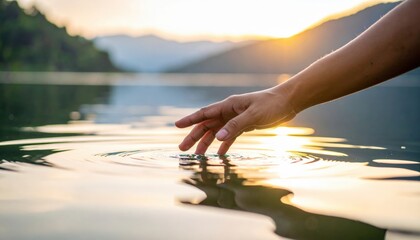 Hand Touching Water At Sunset Lake Landscape