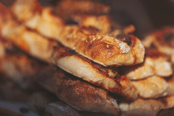 Freshly baked bread loaves resting on a wooden surface in a cozy kitchen during the morning hours