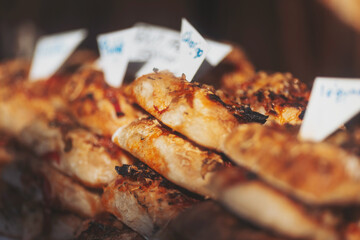 Delicious fresh baked goods displayed in a local market with tempting toppings and vibrant colors...