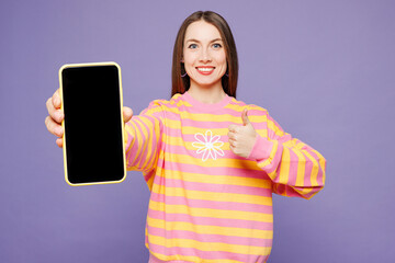 Young woman wear yellow sweatshirt casual clothes hold in hand use mobile cell phone with blank...