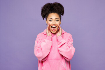 Young woman of African American ethnicity wear pink hoodie casual clothes scream share hot news...