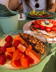 Healthy brunch with yogurt bowl and fruit waffles outdoors