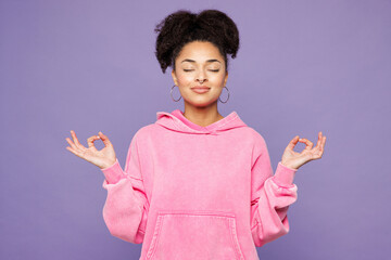 Young woman of African American ethnicity in pink hoodie casual clothes hold spreading hands in...