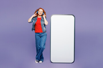 Full body young ginger woman wear red t-shirt denim shirt big huge blank screen mobile cell phone...