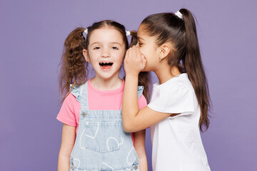 Little two friends kids children girls 9-10 year old wear casual clothes together whispering gossip...