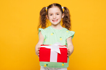 Little smiling cheery kid child girl 8-9 years old wears green t-shirt hold give red present box...