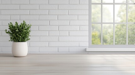 A serene interior scene featuring a potted plant next to a large window with natural light illuminating a white brick wall.