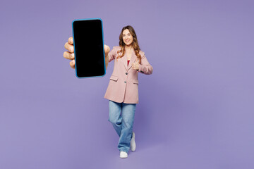 Full body young woman she wearing beige jacket formal clothes hold in hand use mobile cell phone...