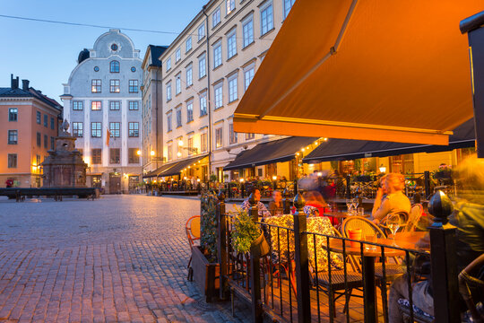 Restaurant and colourful buildings on Stortorget, Old Town Square in Gamla Stan at dusk, Stockholm, Sweden, Scandinavia