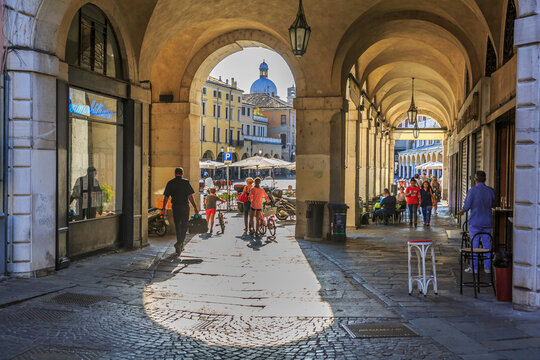 View of Piazza delle Erbe through archways and dome of Padua Cathedral visible, Padua, Veneto, Italy