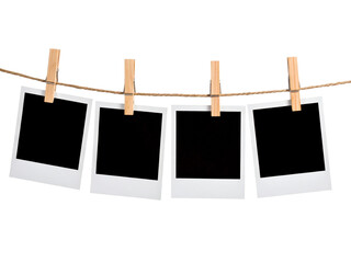 Blank polaroid frames hung up by wooden clothespins, suitable for showcasing memories, creating a photo collage, or adding text overlays.