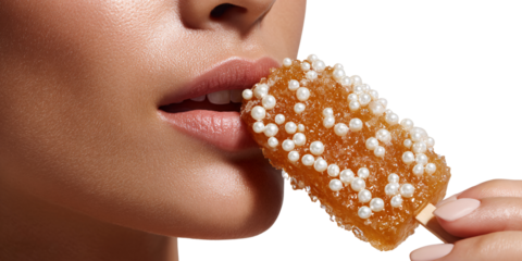 Closeup of Caucasian womans lips biting into a sugary candy stick decorated with pearls Concept of sweet indulgence, beauty, and unique confectionery