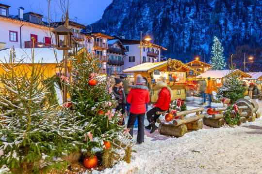 View of Christmas Market stalls at dusk in Campitello di Fassa, Val di Fassa, Trentino, Italy