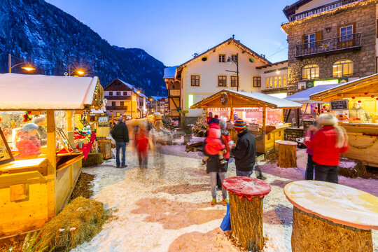 View of Christmas Market stalls at dusk in Campitello di Fassa, Val di Fassa, Trentino, Italy
