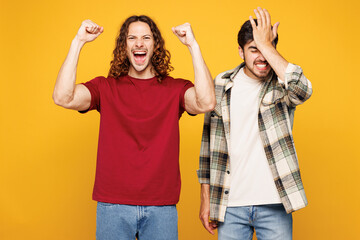 Young sad shocked two friends buddies men wearing casual clothes together do facepalm, winner...