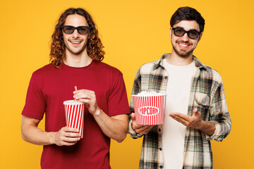 Young happy cheerful two friends buddies men they wear casual clothes 3d glasses watch movie film...