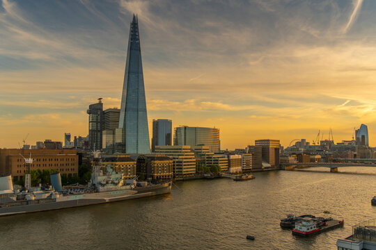 View of The Shard, HMS Belfast and River Thames from Cheval Three Quays at sunset, London, England