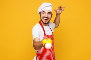 Young housewife housekeeper chef cook baker man he wears red apron toque hat hold skewer with...