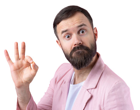 Portrait of a smiling young man in a pink jacket. Man showing ok gesture while standing in studio over isolated red background.