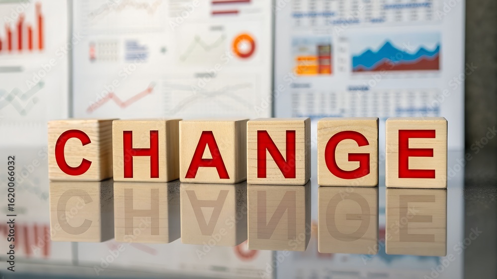 Aufkleber change concept presented by red letters on wooden blocks with business charts in the background demo