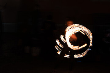 Abstract light painting of a fire circle created by a street performer at night. Concept of energy, motion, infinity and creative performance.