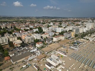 Coastal Urban Vista: An expansive aerial view captures a vibrant seaside town, showcasing an...