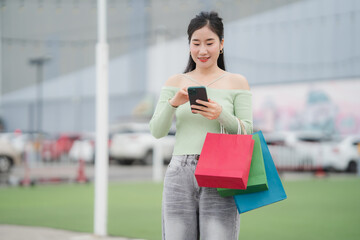 Smart Shopping Moment: A cheerful individual is seen outside shopping venue, holding colorful...