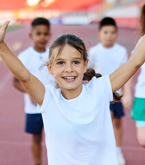 Young children having athletic exercise class running on the track, healthy lifestyle and children sport education concepts, finish line winner celebration, victory and success