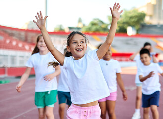 Young children having athletic exercise class running on the track, healthy lifestyle and children...