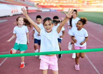 Young children having athletic exercise class running on the track, healthy lifestyle and children...