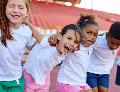 Group portrait of children team havinng exercise athletics class at stadium. Sport, unity, togetherness, teamwork, healthy life concepts