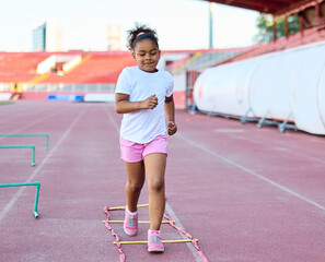 Young children having athletic exercise class running on the track, healthy lifestyle and children...