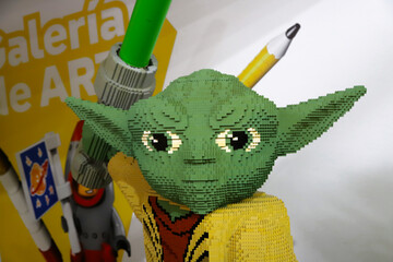 Fototapeta premium Close-up of a statue created with Lego blocks of the character Yoda from the movie Star Wars looking straight ahead