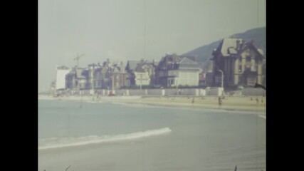 Vintage coastal town in spain, 1977, serene beach and architectural charm