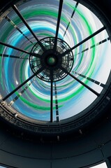 Transparent AI guided wind turbine nacelle interior with glowing airflow visualization ribbons and rotating blades in wind farm project