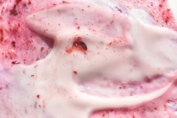 Fototapeta premium Creamy strawberry swirl texture with rich red and pink hues.