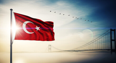 Majestic turkish flag waves proudly against a dramatic sky with a bridge in the background