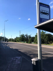 Quiet bus stop on a sunny day in a rural area