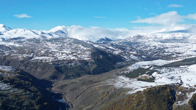 Aerial view of snow-dusted mountains and valleys create a striking contrast against the clear blue sky, Posof, Ardahan, T&Atilde;&frac14;rkiye.